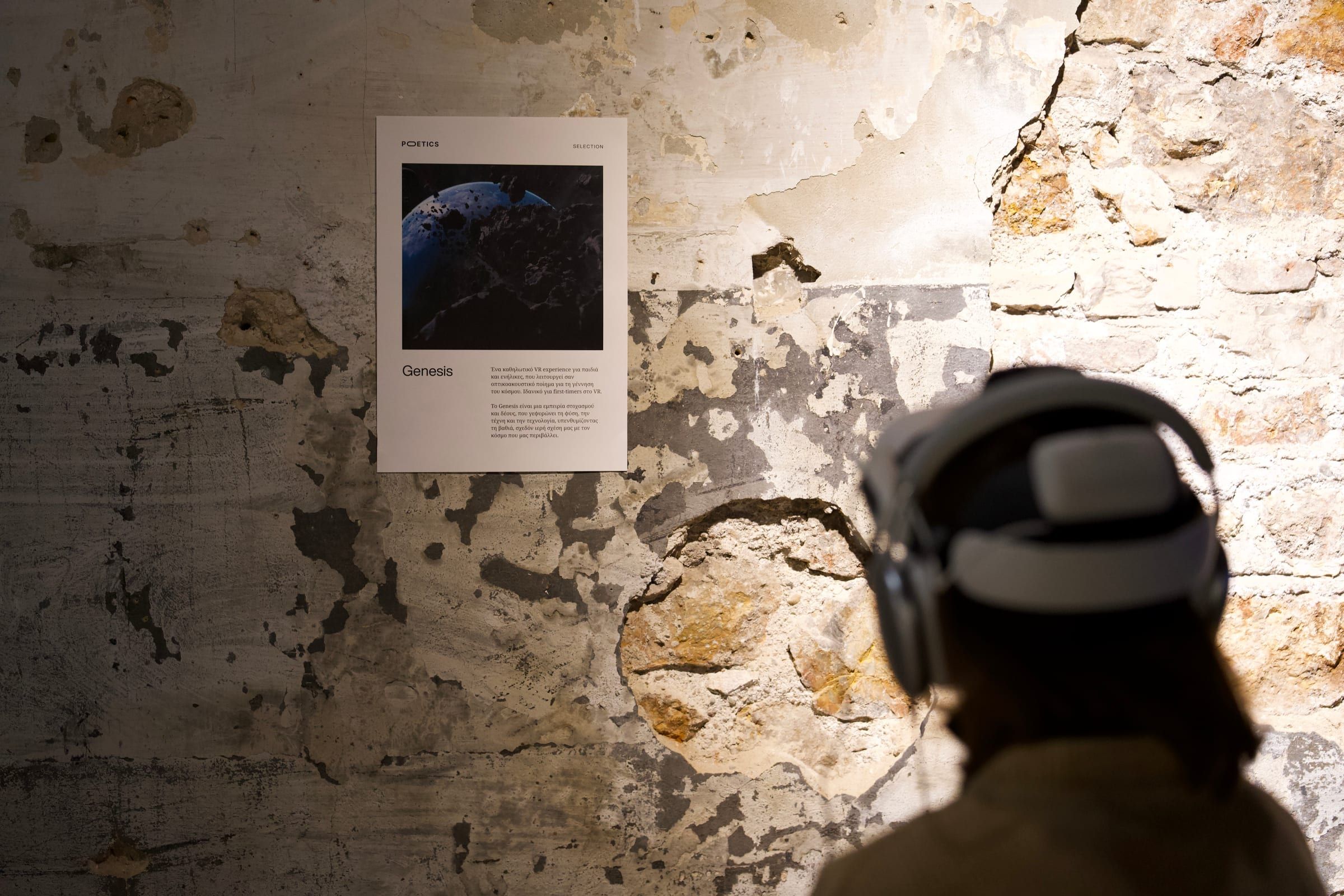 A visitor in a headset facing a panel on a weathered wall.