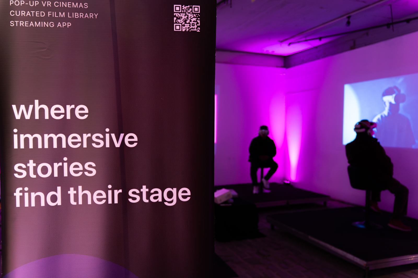A Poetics banner beside a purple-lit VR cinema setup.