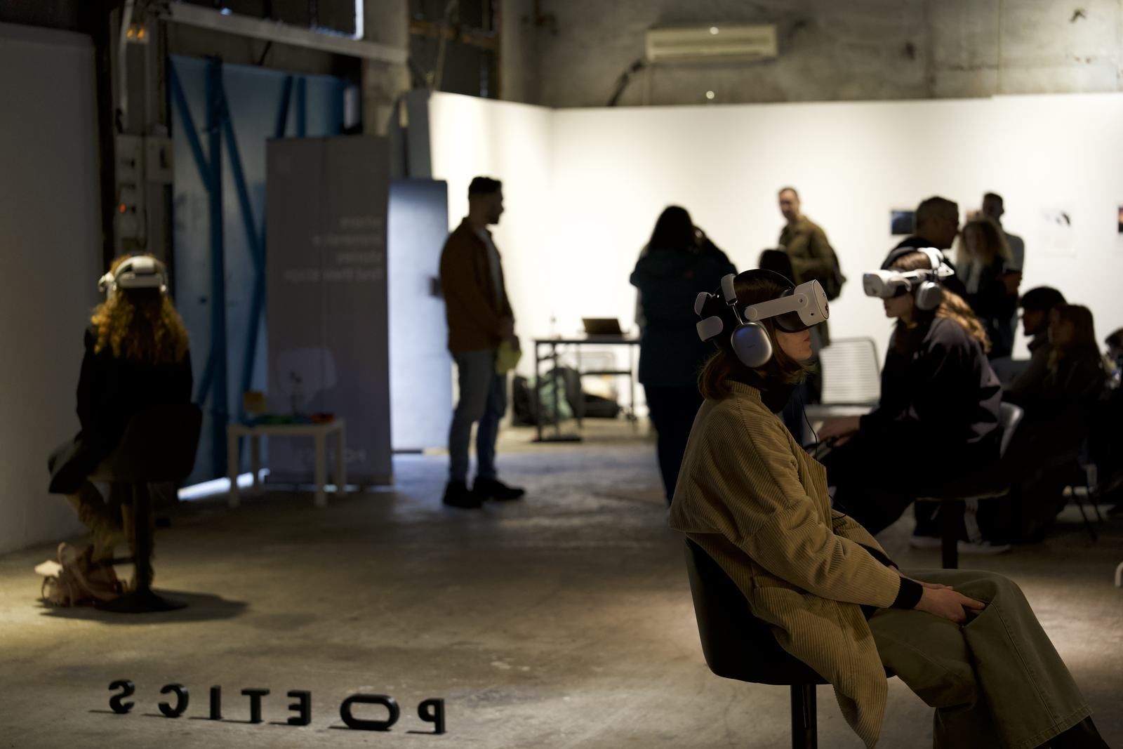 A visitor in a Poetics VR headset, with soft green light in the foreground.