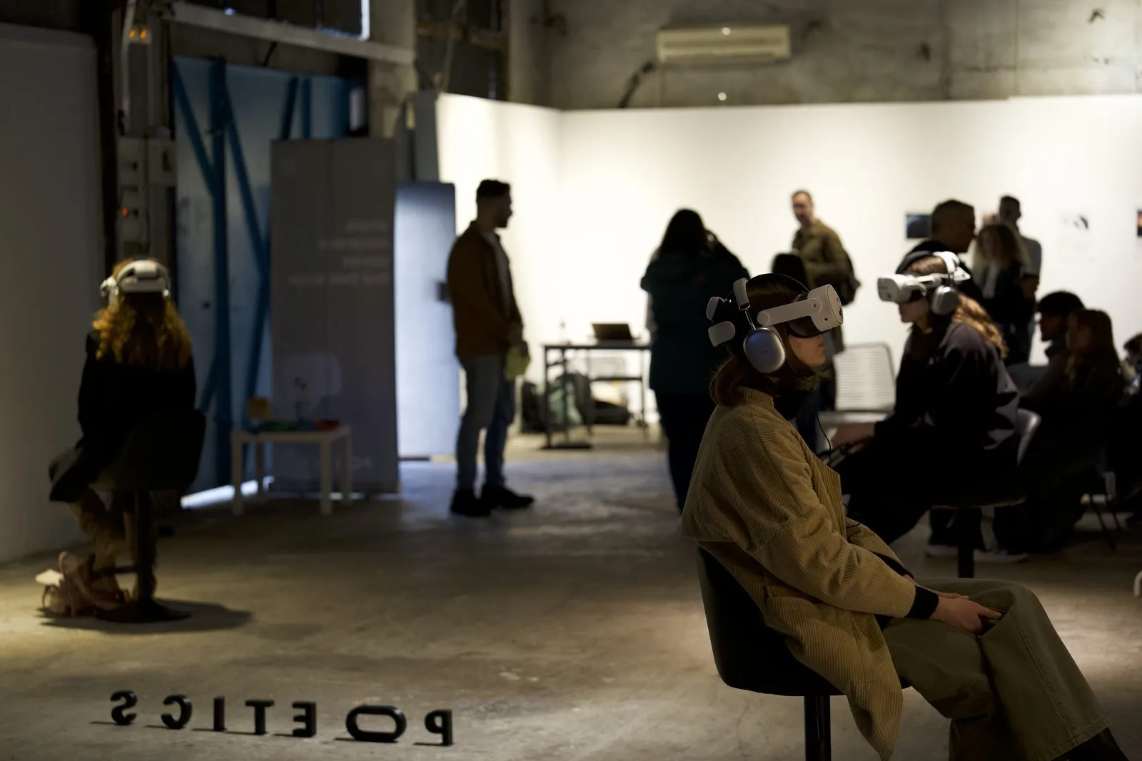 A visitor in a Poetics VR headset, with soft green light in the foreground.