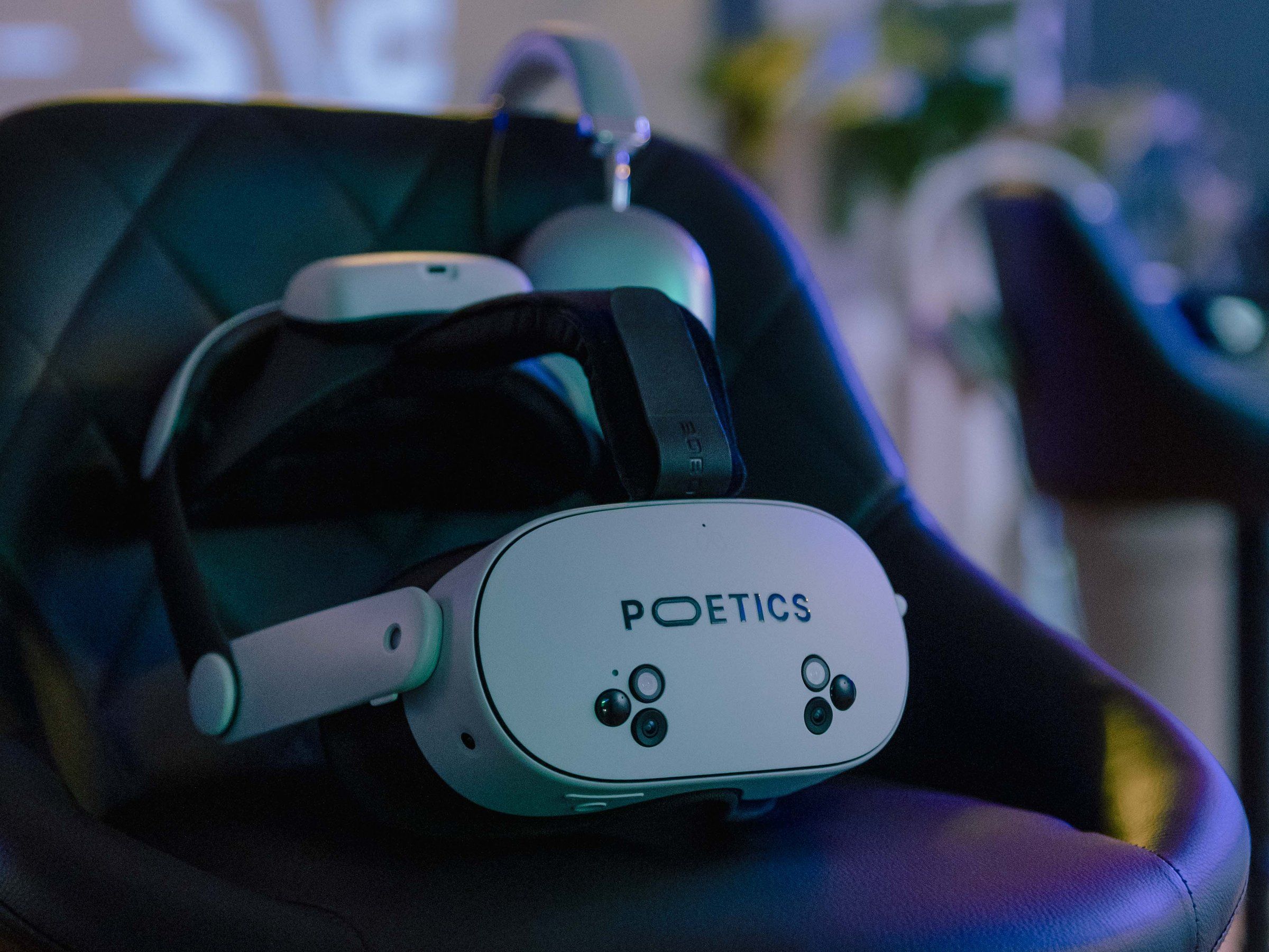 A Poetics headset and headphones resting on a black stool, ready for the next visitor.