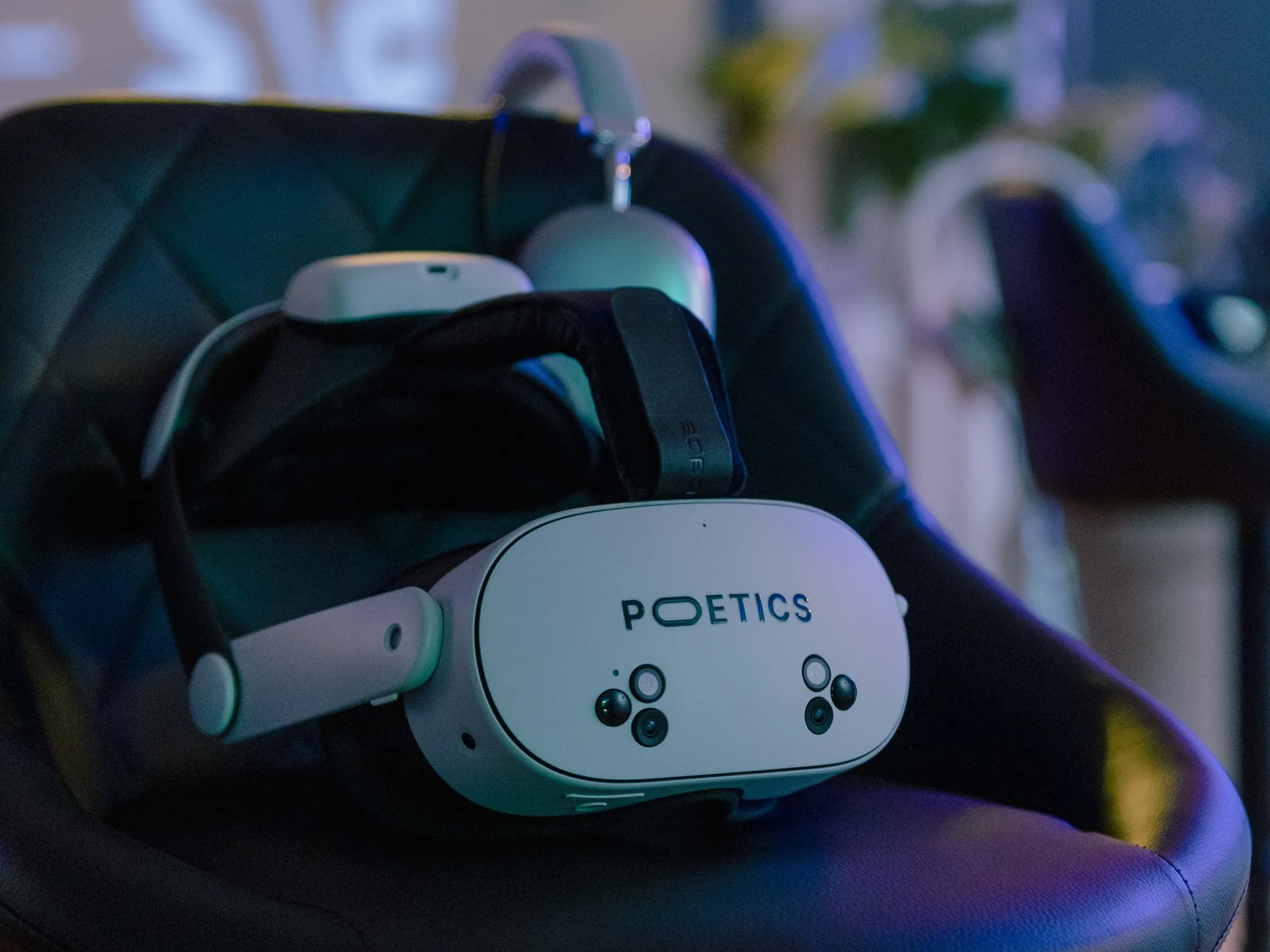 A Poetics headset and headphones resting on a black stool, ready for the next visitor.